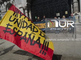 A Spanish flag with the words ''Long live the unity of Spain'' is waved by a supporter during the reading of the manifesto at the demonstrat...