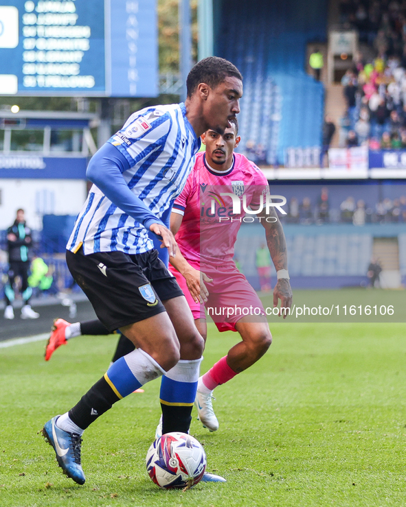 #27, Yan Valery of Sheffield Wednesday, in attacking action pressed by #18, Karlan Grant of WBA during the Sky Bet Championship match betwee...