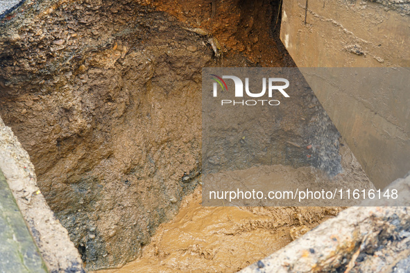 The flooding of the Nakhu River damages the road and riverbank during heavy rainfall in Lalitpur, Nepal, on September 28, 2024. Due to road...