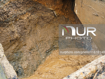 The flooding of the Nakhu River damages the road and riverbank during heavy rainfall in Lalitpur, Nepal, on September 28, 2024. Due to road...