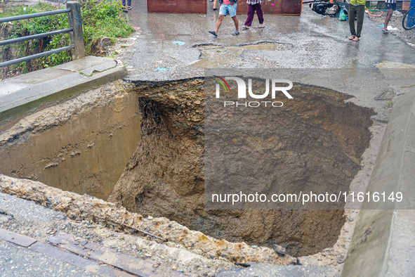 The flooding of the Nakhu River damages the road and riverbank during heavy rainfall in Lalitpur, Nepal, on September 28, 2024. Due to road...