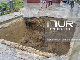 The flooding of the Nakhu River damages the road and riverbank during heavy rainfall in Lalitpur, Nepal, on September 28, 2024. Due to road...