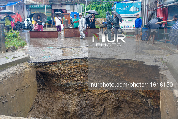 The flooding of the Nakhu River damages the road and riverbank during heavy rainfall in Lalitpur, Nepal, on September 28, 2024. Due to road...