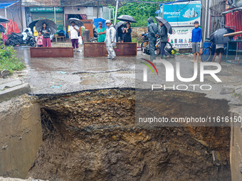 The flooding of the Nakhu River damages the road and riverbank during heavy rainfall in Lalitpur, Nepal, on September 28, 2024. Due to road...