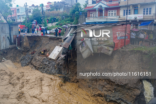 The flooding of the Nakhu River damages the road and riverbank during heavy rainfall in Lalitpur, Nepal, on September 28, 2024. Due to road...