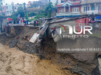 The flooding of the Nakhu River damages the road and riverbank during heavy rainfall in Lalitpur, Nepal, on September 28, 2024. Due to road...