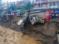 The flooding of the Nakhu River damages the road and riverbank during heavy rainfall in Lalitpur, Nepal, on September 28, 2024. Due to road...