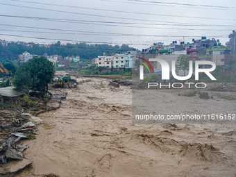 The flooding of the Nakhu River damages the road and riverbank during heavy rainfall in Lalitpur, Nepal, on September 28, 2024. Due to road...