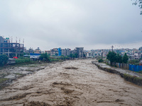 The flooding of the Nakhu River damages the road and riverbank during heavy rainfall in Lalitpur, Nepal, on September 28, 2024. Due to road...