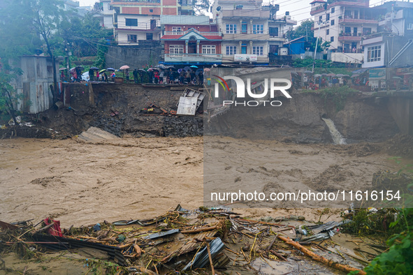 The flooding of the Nakhu River damages the road and riverbank during heavy rainfall in Lalitpur, Nepal, on September 28, 2024. Due to road...