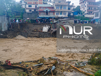 The flooding of the Nakhu River damages the road and riverbank during heavy rainfall in Lalitpur, Nepal, on September 28, 2024. Due to road...