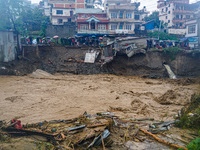 The flooding of the Nakhu River damages the road and riverbank during heavy rainfall in Lalitpur, Nepal, on September 28, 2024. Due to road...