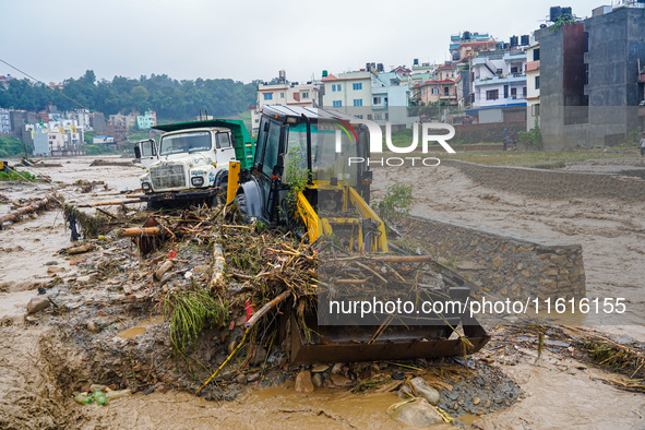 The flooding of the Nakhu River damages the road and riverbank during heavy rainfall in Lalitpur, Nepal, on September 28, 2024. Due to road...