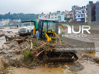 The flooding of the Nakhu River damages the road and riverbank during heavy rainfall in Lalitpur, Nepal, on September 28, 2024. Due to road...