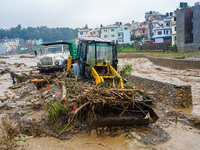 The flooding of the Nakhu River damages the road and riverbank during heavy rainfall in Lalitpur, Nepal, on September 28, 2024. Due to road...