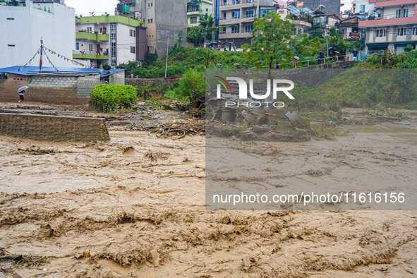 The flooding of the Nakhu River damages the road and riverbank during heavy rainfall in Lalitpur, Nepal, on September 28, 2024. Due to road...