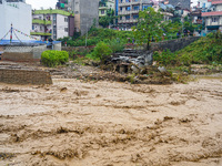 The flooding of the Nakhu River damages the road and riverbank during heavy rainfall in Lalitpur, Nepal, on September 28, 2024. Due to road...