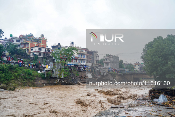 The flooding of the Nakhu River damages the road and riverbank during heavy rainfall in Lalitpur, Nepal, on September 28, 2024. Due to road...