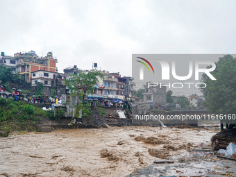 The flooding of the Nakhu River damages the road and riverbank during heavy rainfall in Lalitpur, Nepal, on September 28, 2024. Due to road...