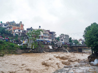 The flooding of the Nakhu River damages the road and riverbank during heavy rainfall in Lalitpur, Nepal, on September 28, 2024. Due to road...