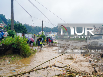 The flooding of the Nakhu River damages the road and riverbank during heavy rainfall in Lalitpur, Nepal, on September 28, 2024. Due to road...