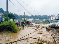 The flooding of the Nakhu River damages the road and riverbank during heavy rainfall in Lalitpur, Nepal, on September 28, 2024. Due to road...