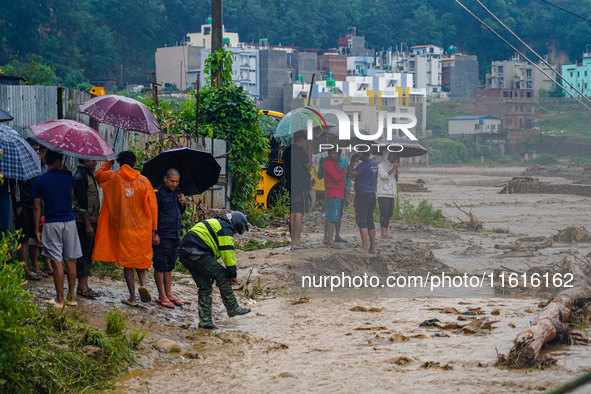 The flooding of the Nakhu River damages the road and riverbank during heavy rainfall in Lalitpur, Nepal, on September 28, 2024. Due to road...