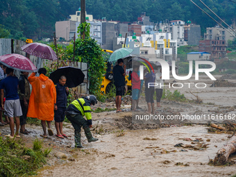 The flooding of the Nakhu River damages the road and riverbank during heavy rainfall in Lalitpur, Nepal, on September 28, 2024. Due to road...