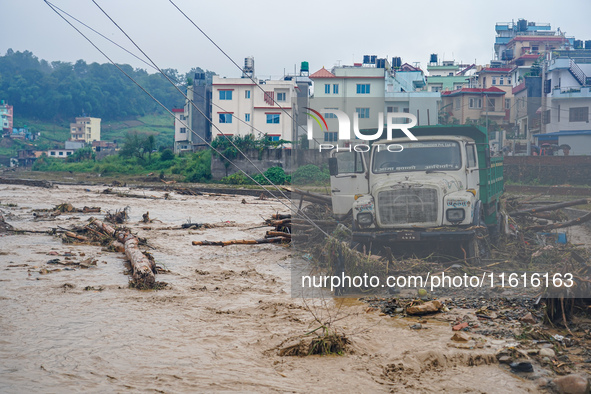 The flooding of the Nakhu River damages the road and riverbank during heavy rainfall in Lalitpur, Nepal, on September 28, 2024. Due to road...