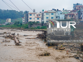 The flooding of the Nakhu River damages the road and riverbank during heavy rainfall in Lalitpur, Nepal, on September 28, 2024. Due to road...