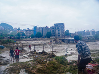 People's daily lives are affected due to heavy rainfall and flooding of the Nakhu River in Kathmandu, Nepal, on September 27, 2024. (