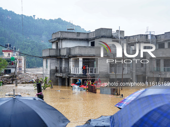 The rescue team rescues those trapped in the Nakhu River flood in Lalitpur, Nepal, on September 28, 2024. (