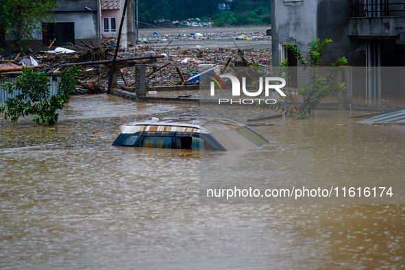 Vehicles are submerged in the flooding of the Nakhu River in Lalitpur, Nepal, on September 28, 2024. 