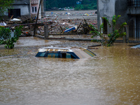 Vehicles are submerged in the flooding of the Nakhu River in Lalitpur, Nepal, on September 28, 2024. (