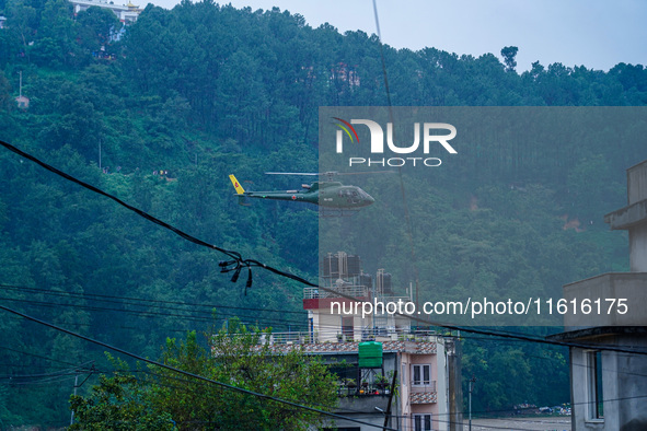 The rescue team of the Nepal Army rescues those trapped in the Nakhu River flood in Lalitpur, Nepal, on September 28, 2024, by helicopter. 