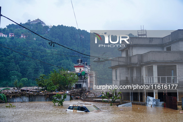 The rescue team of the Nepal Army rescues those trapped in the Nakhu River flood in Lalitpur, Nepal, on September 28, 2024, by helicopter. 