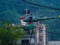 The rescue team of the Nepal Army rescues those trapped in the Nakhu River flood in Lalitpur, Nepal, on September 28, 2024, by helicopter. (