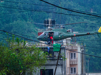 The rescue team of the Nepal Army rescues those trapped in the Nakhu River flood in Lalitpur, Nepal, on September 28, 2024, by helicopter. (