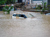 Vehicles are submerged in the flooding of the Nakhu River in Lalitpur, Nepal, on September 28, 2024. (