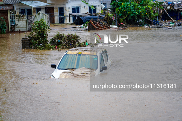 Vehicles are submerged in the flooding of the Nakhu River in Lalitpur, Nepal, on September 28, 2024. 