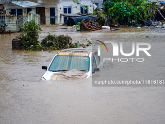 Vehicles are submerged in the flooding of the Nakhu River in Lalitpur, Nepal, on September 28, 2024. (