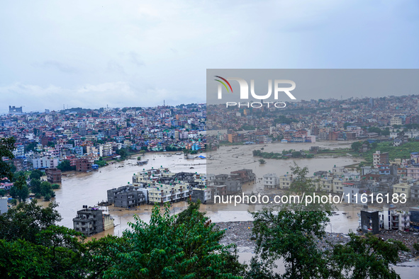 The Nakhu River floods and affects the riverbanks and homes during heavy rainfall in Lalitpur, Nepal, on September 28, 2024. 