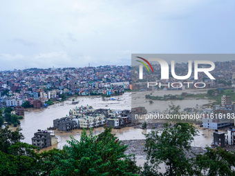 The Nakhu River floods and affects the riverbanks and homes during heavy rainfall in Lalitpur, Nepal, on September 28, 2024. (