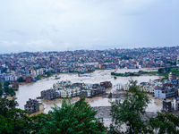 The Nakhu River floods and affects the riverbanks and homes during heavy rainfall in Lalitpur, Nepal, on September 28, 2024. (