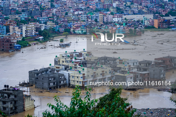 The Nakhu River floods and affects the riverbanks and homes during heavy rainfall in Lalitpur, Nepal, on September 28, 2024. 