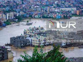 The Nakhu River floods and affects the riverbanks and homes during heavy rainfall in Lalitpur, Nepal, on September 28, 2024. (