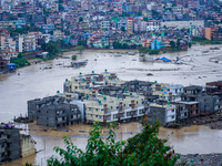 The Nakhu River floods and affects the riverbanks and homes during heavy rainfall in Lalitpur, Nepal, on September 28, 2024. (