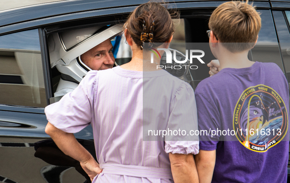 Nick Hague talks with his family from inside the car that will carry him and Alexander Gorbunov to launch pad 40 at the Cape Canaveral Space...