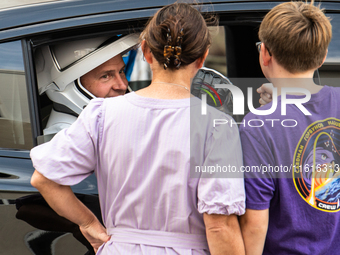 Nick Hague talks with his family from inside the car that will carry him and Alexander Gorbunov to launch pad 40 at the Cape Canaveral Space...