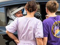 Nick Hague talks with his family from inside the car that will carry him and Alexander Gorbunov to launch pad 40 at the Cape Canaveral Space...